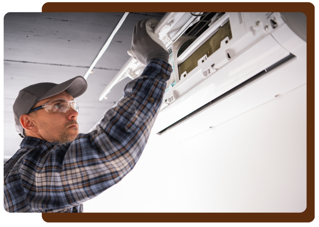 Image of a Contractor fixing an indoor mini split head.